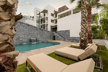 Sunbeds in front of a hotel swimming pool