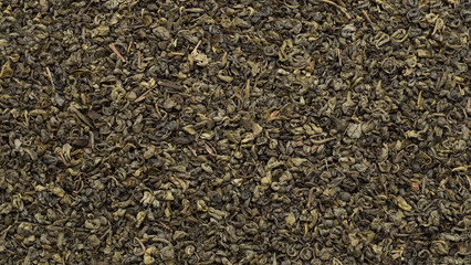 Twisted green tea leaves background.