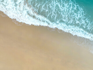 The aerial view of a summer tropical with Waves crashing on the beach