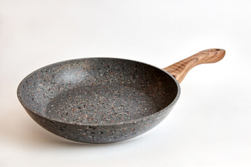 Quality frying pan made of cast iron alloy on a white background.
