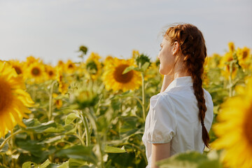 woman with two pigtails in a white dress admires nature landscape