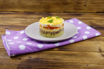 Traditional russian salad Mimosa on wooden table