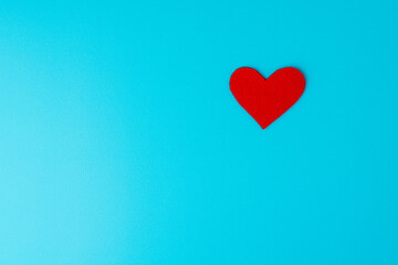Fototapeta na wymiar Concept of charity and healthcare donation. Heart symbol of love and romance on turquoise background
