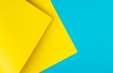 Urkaine yellow and blue colored background of layered cardboard sheets, top view, copy space