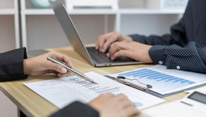 Business brainstorming, Marketers and conference leaders on business plans and marketing strategies using laptop for data analysis, Using business data graphs in meetings.