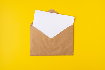 Realistic mockup blank white letter craft paper envelope on yellow backdrop front view, template
