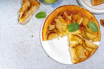 Classic upside-down apple cake. Retro apple cake recipe, cooked in frying pan easy autumn summer homemade baking sweet pastry, with fresh green apples copy space