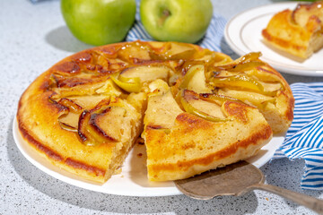 Classic upside-down apple cake. Retro apple cake recipe, cooked in frying pan easy autumn summer homemade baking sweet pastry, with fresh green apples copy space