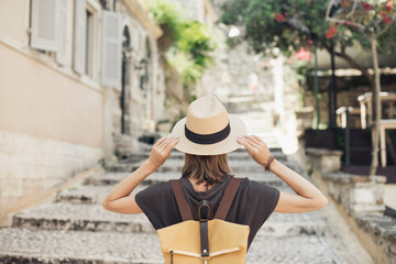 Travel concept, beautiful tourist woman walking in Kerkyra old town during vacation, cheerful student girl traveling abroad in summer, Corfu island, Greece - obrazy, fototapety, plakaty