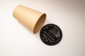 Beige plastic cup with black lid.