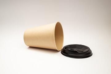 Beige plastic cup with black lid.