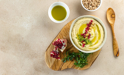 Healthy homemade hummus, made with tahini, lime, olive oil, and chickpeas. Perfect for dipping and can be used in sandwiches, salads, and burgers. Flat lay, copy space for the recipe.