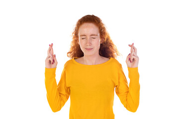 Hopeful pretty ginger girl curly hairstyle squinting praying cross fingers good luck awaiting...