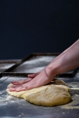 master pizza maker preparing the dough in an artisan way to put it in the oven