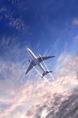 Vertical nature background with aircraft and Jet trailing smoke in sunset sky. Airplane and...