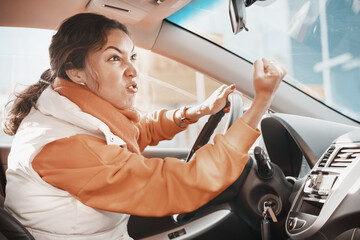 Aggressive female driver swears and shouts and gestures at other road users who violate traffic rules. Concept of anger and emotion management - obrazy, fototapety, plakaty