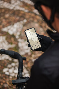 Cyclist checking direction on mobile phone