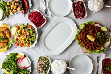 various appetizers next to white empty plate