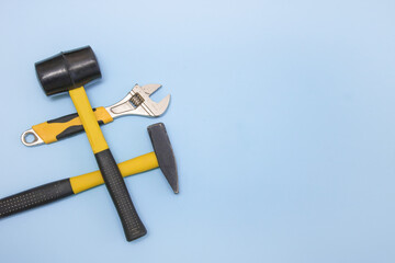 hammer, mallet, sanitary key on a light blue background with copy space