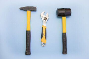 hammer, mallet, sanitary key on a light blue background