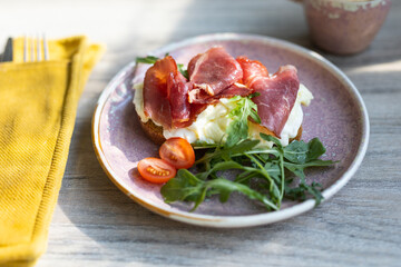 Breakfast sandwich. Scrambled eggs and jamon on whole grain bread