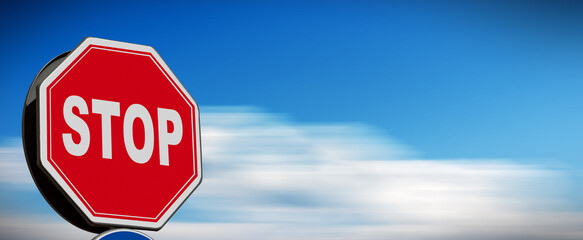 Closeup of a stop road sign against a blurred clear sky with clouds and copy space. Photography,...