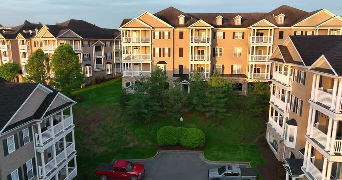 Apartment housing building in USA at golden hour. Aerial of apt unit rentals in upscale new homes.