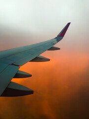 Hazy airplane wing view sunny cinematic panorama during flight over land copy paste vertical...