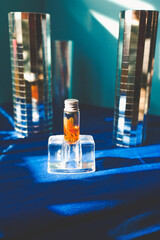 A little bottle of essencial oil in a disco background set