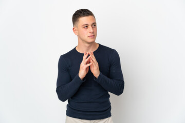 Young caucasian man isolated on white background scheming something