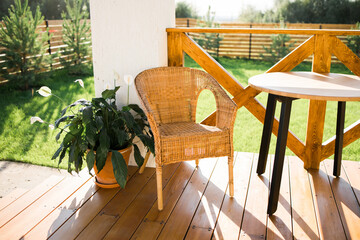 Cozy wooden terrace of country house or cottage with garden view - table and chair for relaxing evening