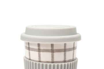 Checkered ceramic cup with rubber lid, shot against a white background.