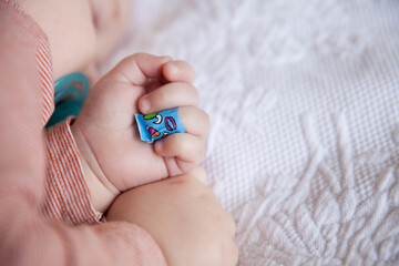 Cute sleeping baby with a band-aid on his finger