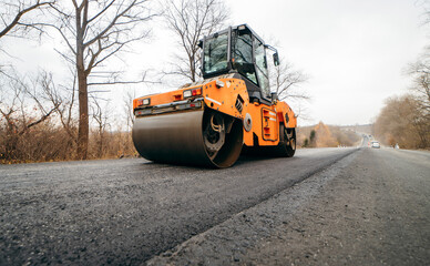 Vibratory asphalt rollers compactor compacting new asphalt pavement. Road service build a new highway	
