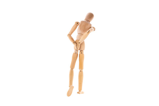 wooden man walks sad with his hands behind his back isolated on white background