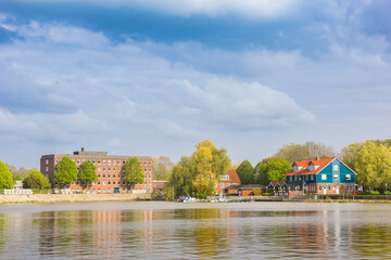 Colorful house and apartment building at the Leda river in Leer, Germany