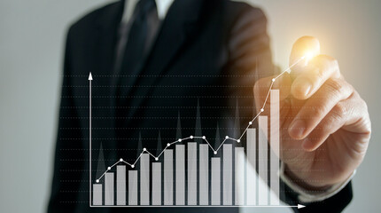 Businessman hand showing graph on touch screen.