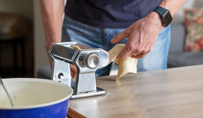 Fototapeta na wymiar Fresh pasta maker machine. Dough homemade preparation. Hand make dough phylo close up view