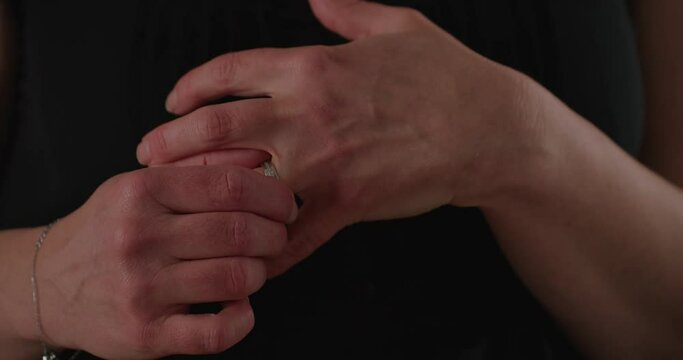 Close up of woman removing her wedding ring in an illicit manner. 