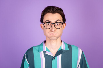 Photo of young funky guy pouted cheeks hold breath fool comic eyewear isolated over violet color...