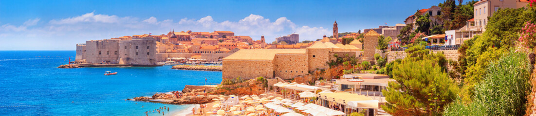 Fototapeta premium Coastal summer landscape, panorama - view of the city beach on the background of the Old Town of Dubrovnik on the Adriatic coast of Croatia