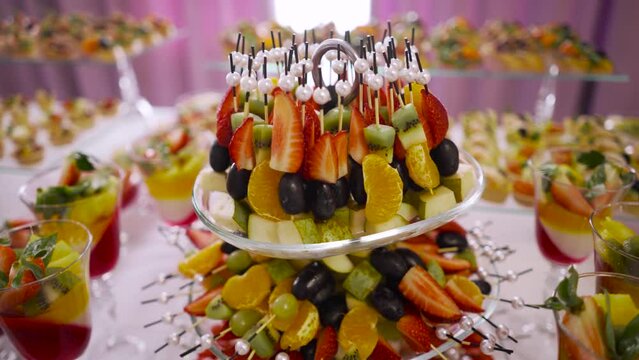 Delicious colorful variety of fruit snacks served at the buffet. The concept of a delicious snack.