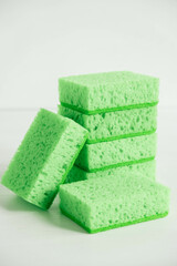 Green sponges for cleaning on a white background