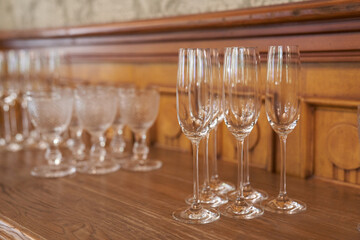 Empty glasses, standing on the table in the restaurant. Empty wine glasses. A set of alcoholic glasses. High quality photo