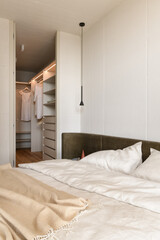 bedroom in white and beige tones, bedroom with wardrobe, bedroom interior in loft style