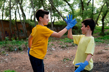 Children high fives with blue gloves.