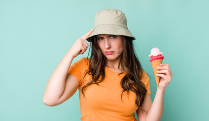young pretty woman  feeling confused and puzzled, showing you are insane. summer and ice cream...