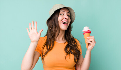 young pretty woman  smiling happily, waving hand, welcoming and greeting you. summer and ice cream...