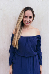 Fototapeta premium Portrait of a beautiful woman in casual clothing standing on the street