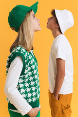 White girl and boy i hats looking at different directions